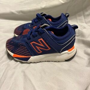 Blue orange and white new balances baby shoes worn